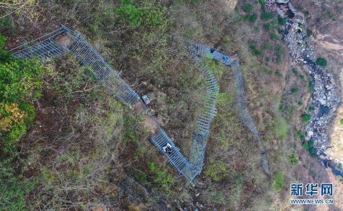 在四川省涼山彝族自治州昭覺縣阿土列爾村的懸崖鋼梯上，村民沿著鋼梯下山（2020年5月13日攝，無人機照片）。新華社記者 王曦 攝