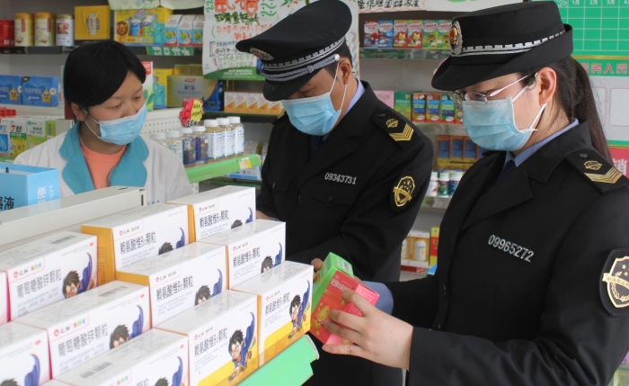圖為執(zhí)法人員在藥店進(jìn)行檢查。