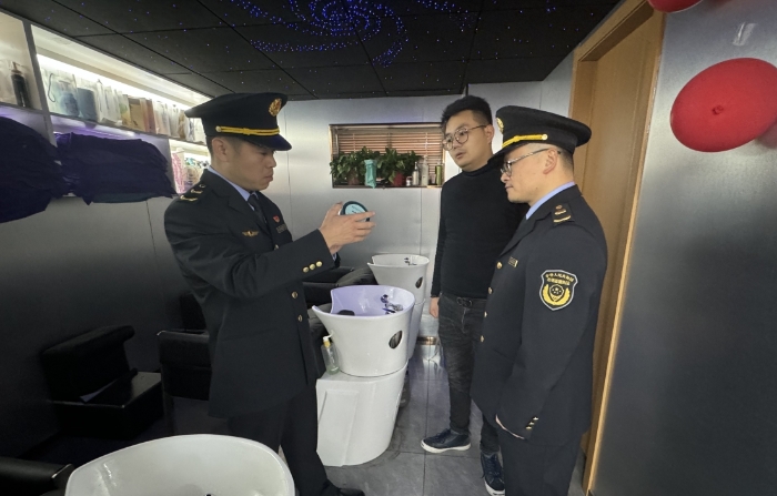 圖為執(zhí)法人員正在一家美容美發(fā)機(jī)構(gòu)進(jìn)行現(xiàn)場檢查。