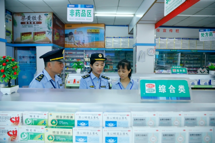 圖為6月25日，南陽鎮(zhèn)市場監(jiān)管所執(zhí)法人員在一家藥店進(jìn)行檢查。（何正君 攝）